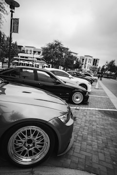 Several cars parked in a row on a street.