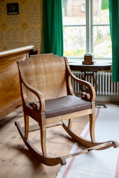 Antique wooden rocking chair with leather seat.