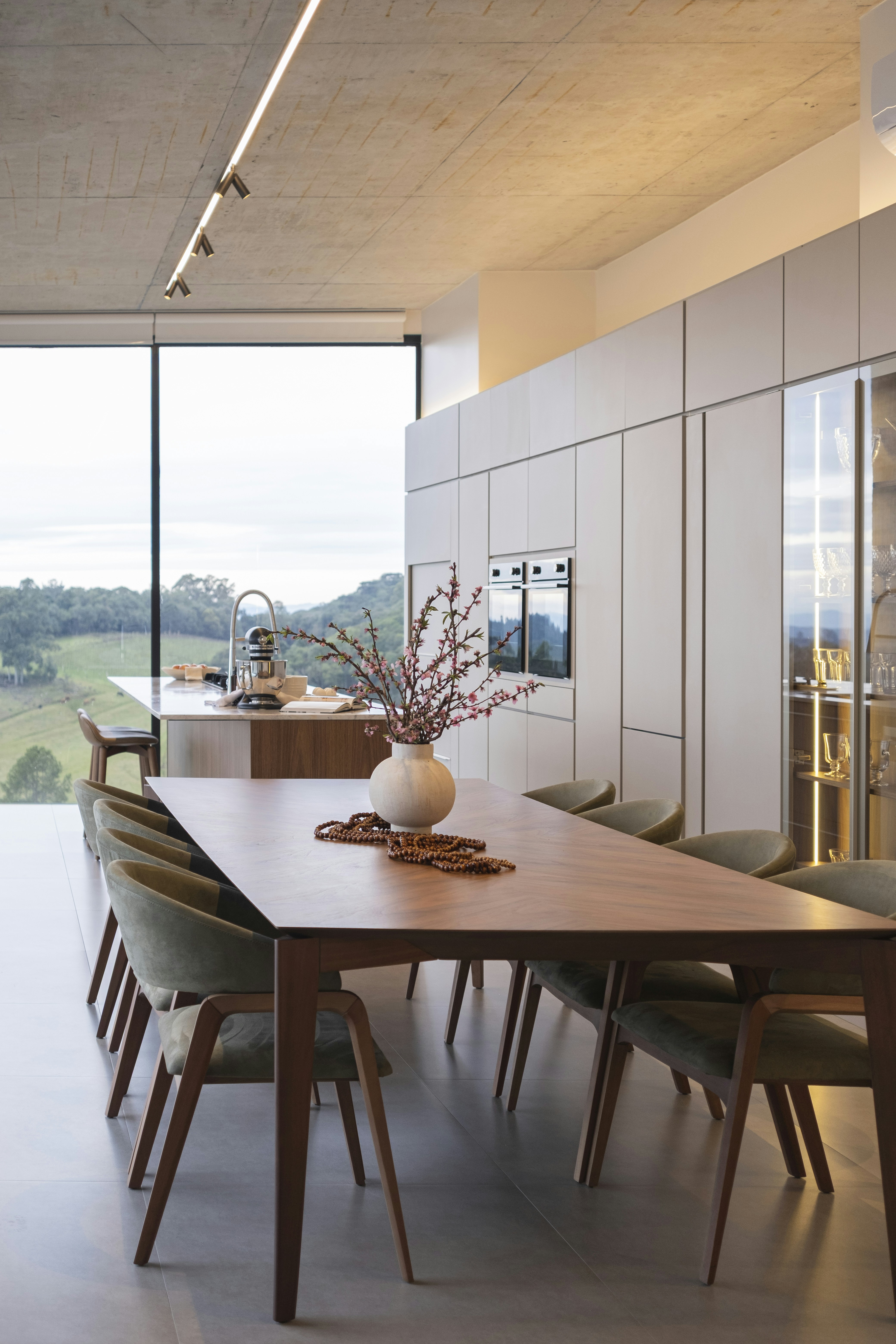 Modern dining room with large window and scenic view.