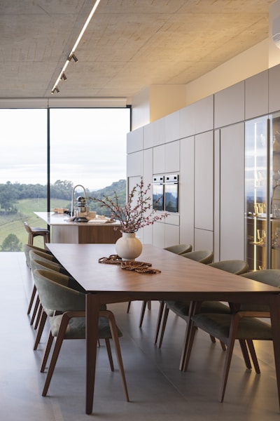 Modern dining room with large window and scenic view.