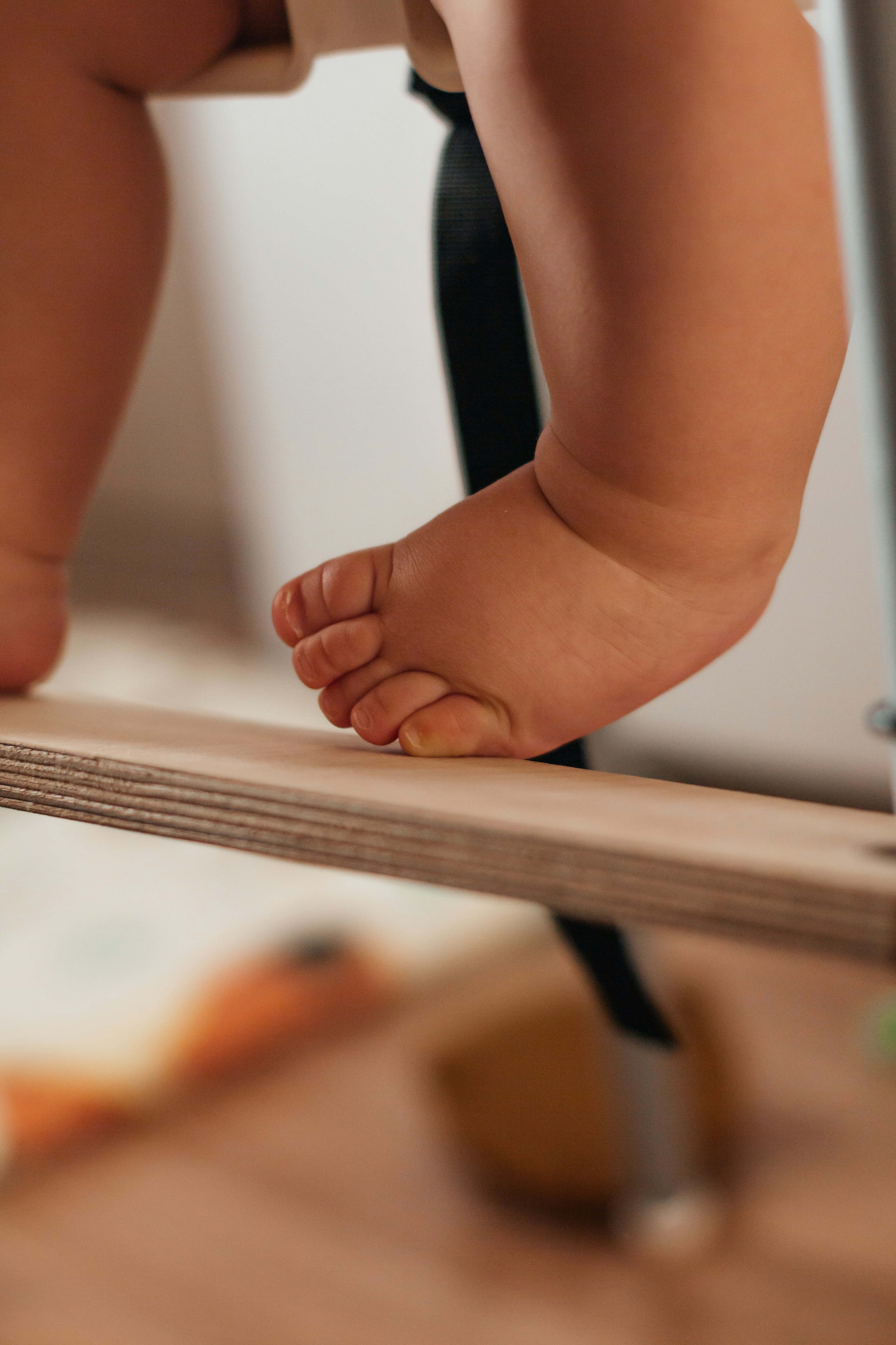 Close up of a baby's foot on a wooden surface
