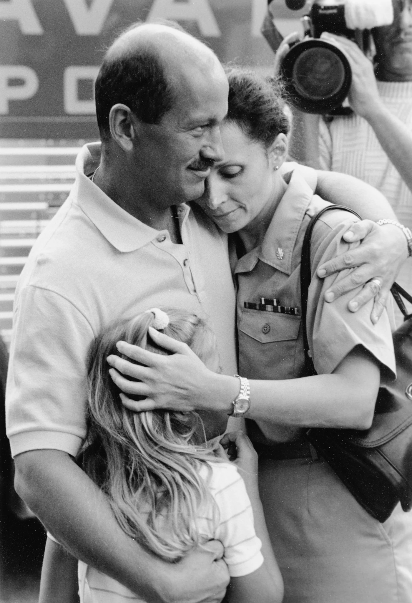 A military family reuniting with a hug
