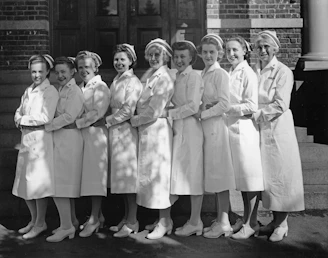 A group of nurses in uniform stand together