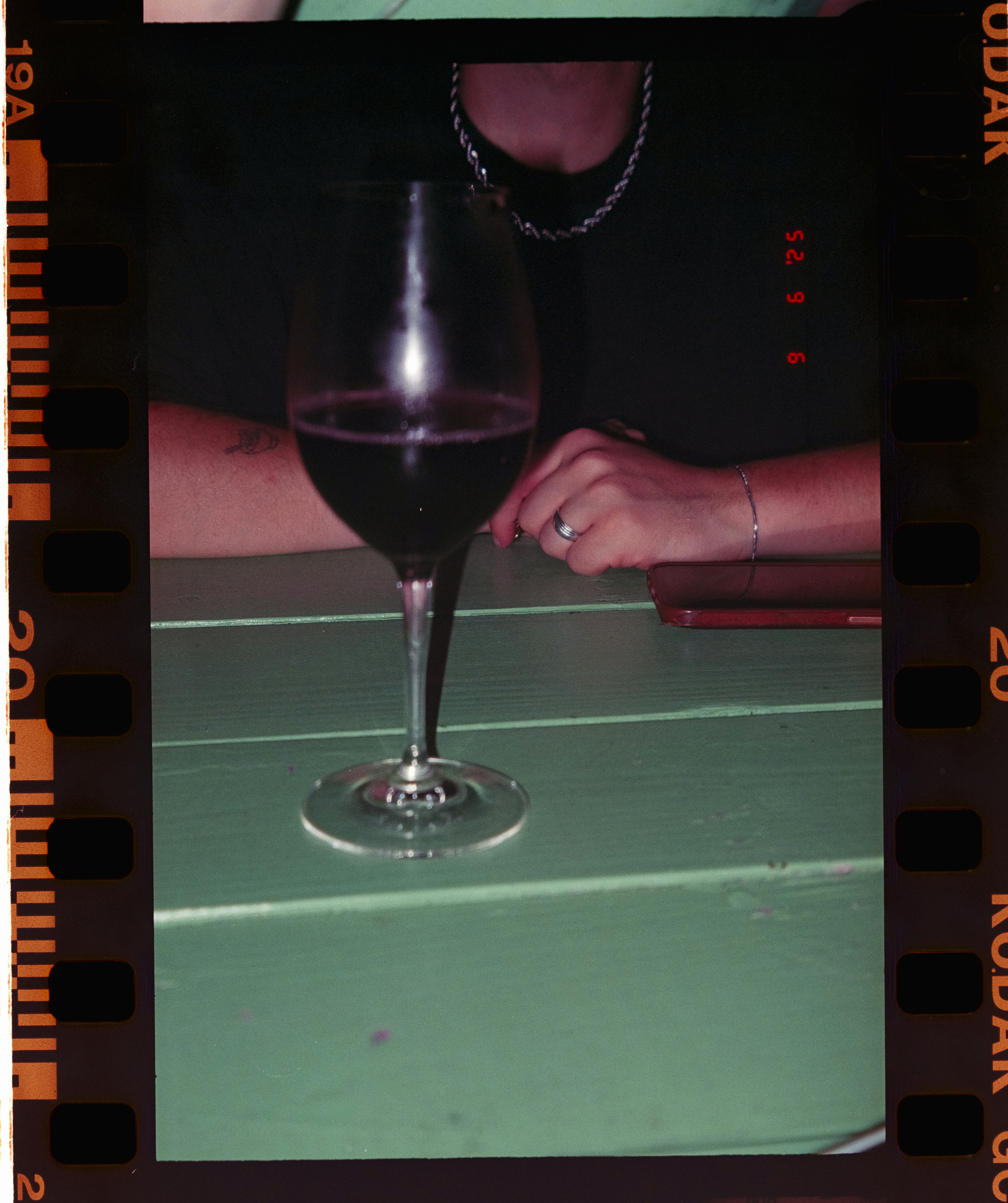 Glass of red wine on a green table