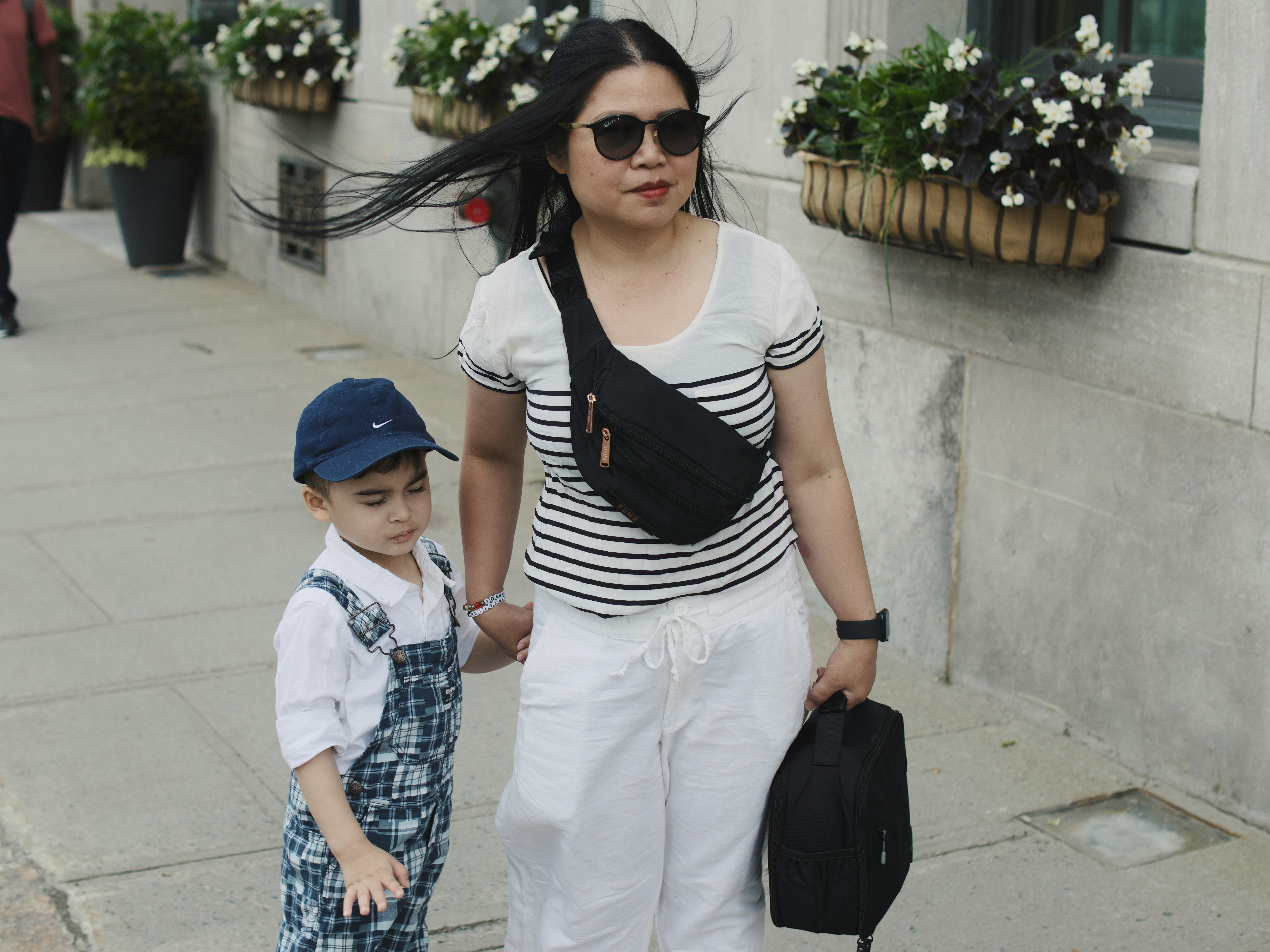Woman and child walking on a sidewalk