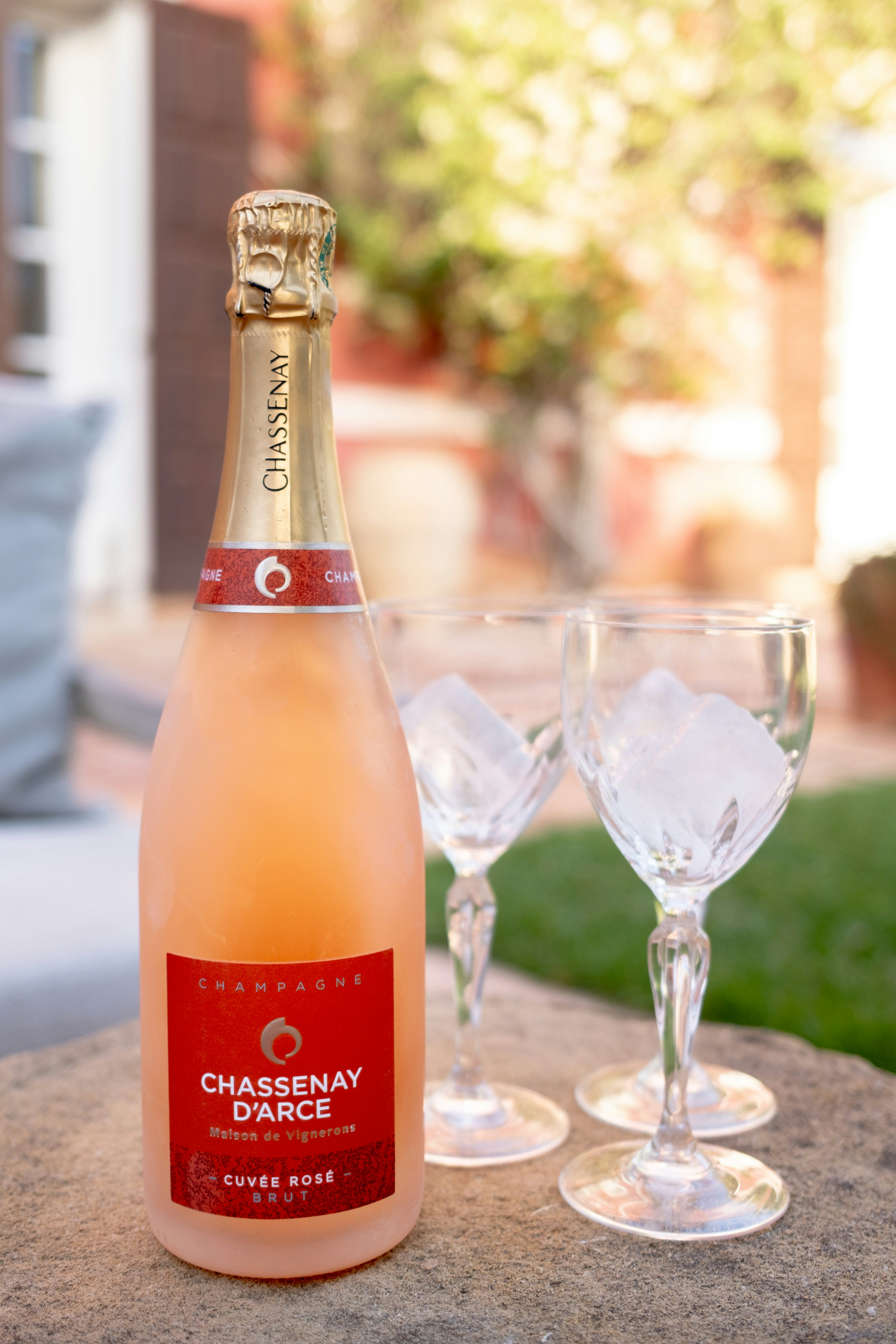 Bottle of rose champagne with two glasses of ice