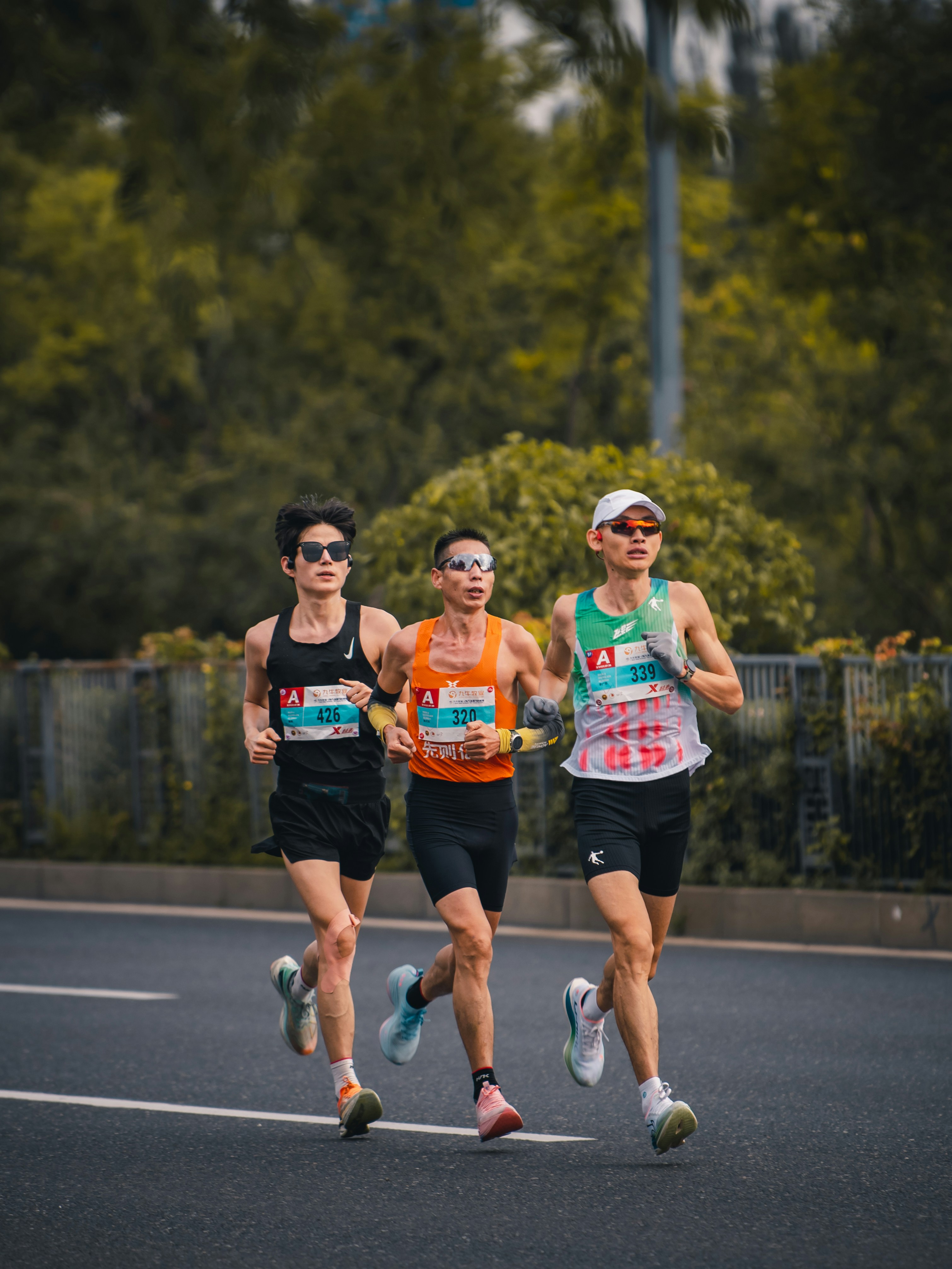 Three runners compete in a marathon race.