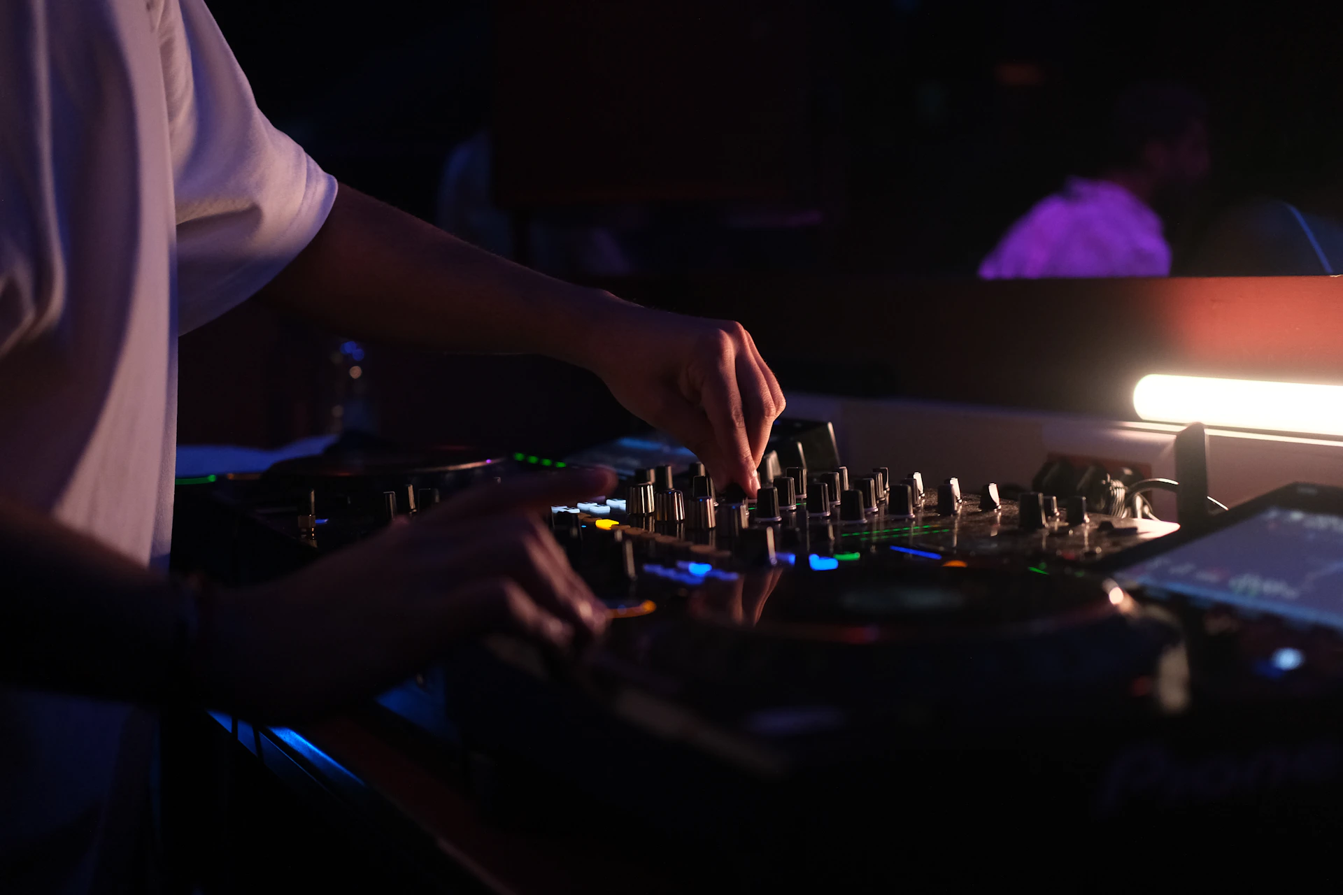 Dj hands adjusting controls on a sound mixer