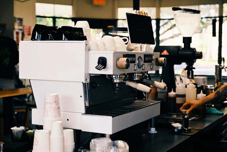 A barista preparing coffee at the espresso machine