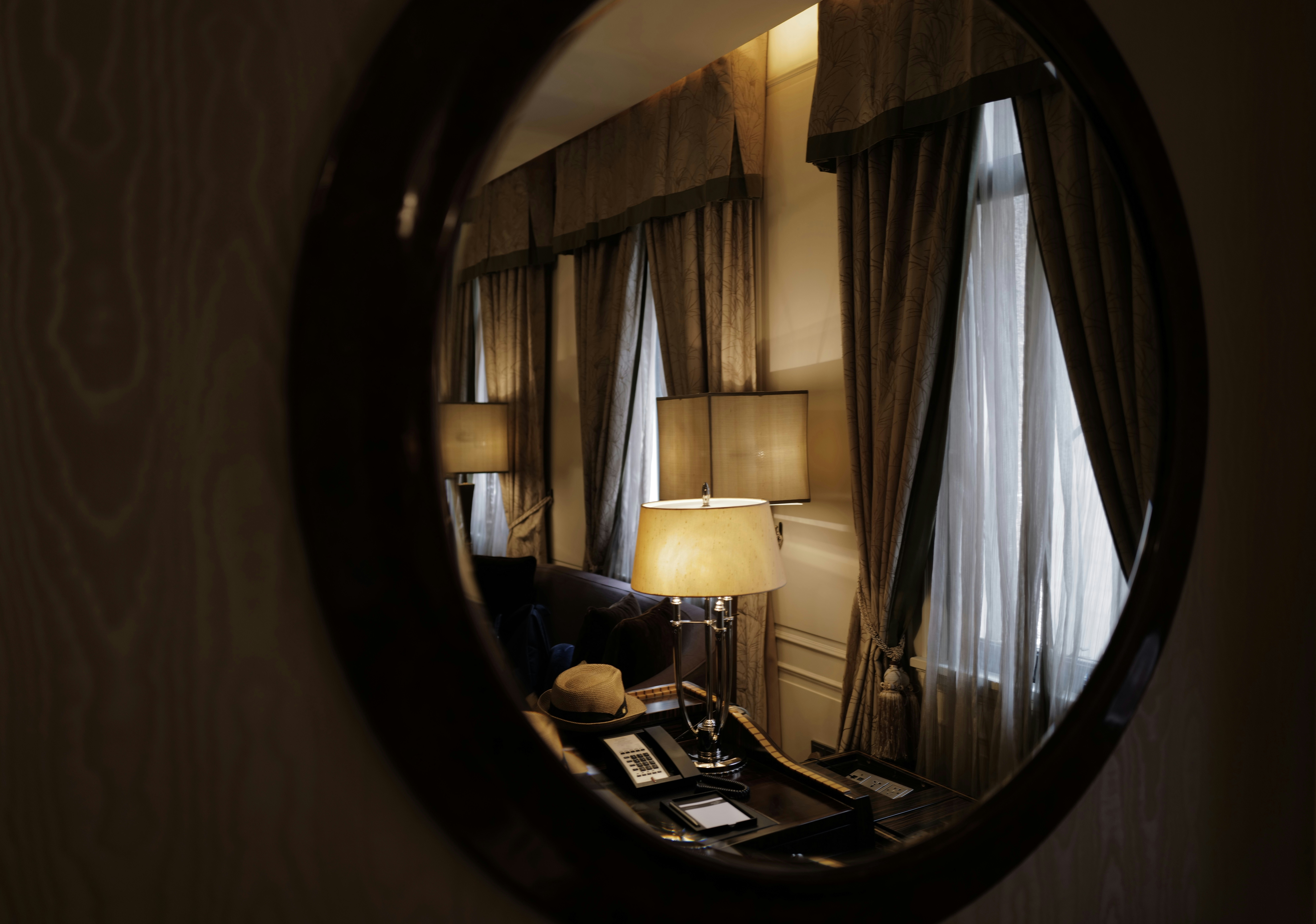 Hotel room reflection in round mirror