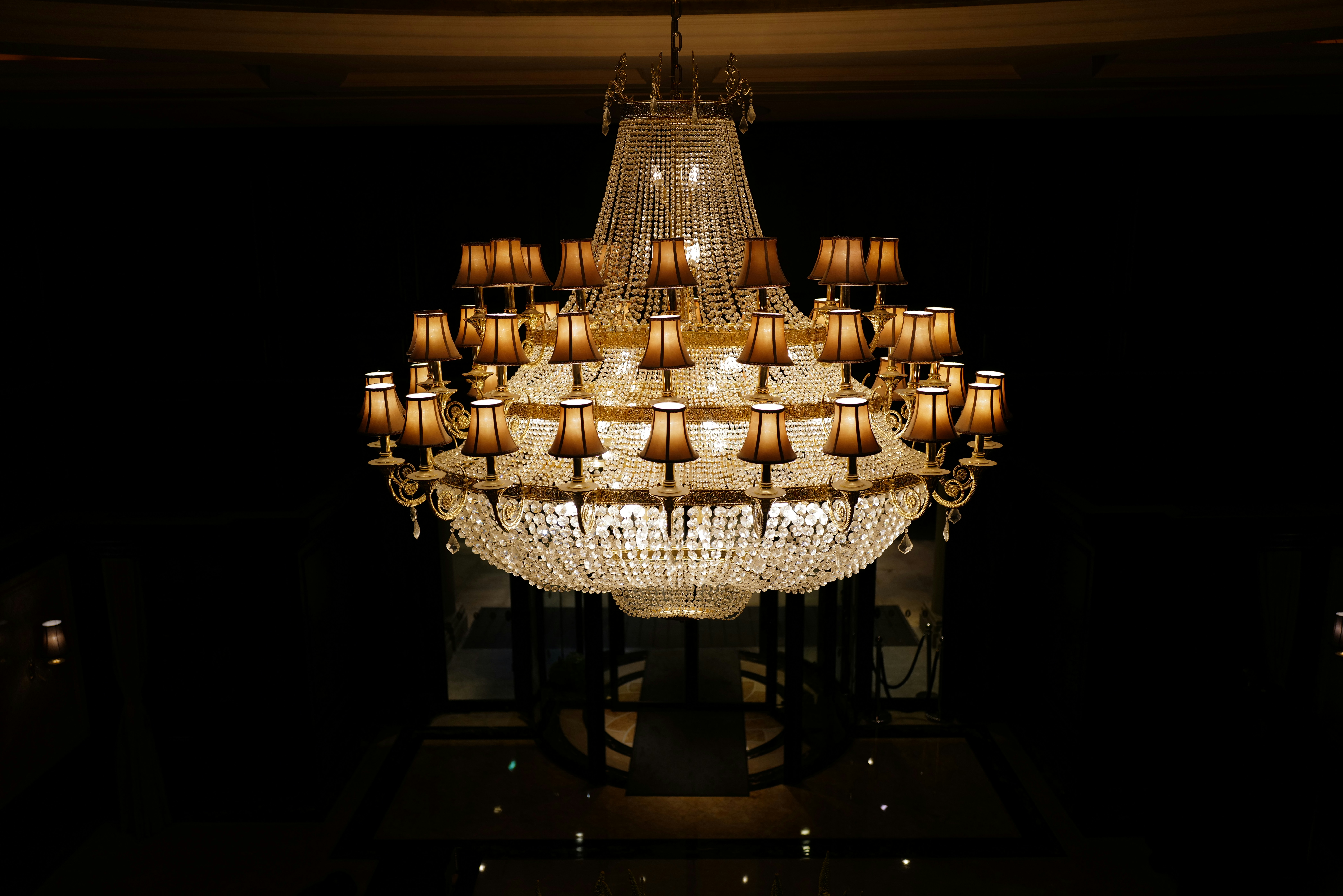 Elaborate crystal chandelier illuminated against dark background
