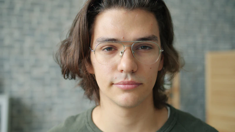 Young man with glasses and long brown hair