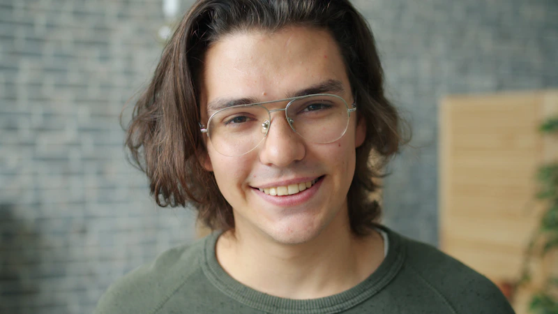 Young, charismatic sugar baby with glasses smiling