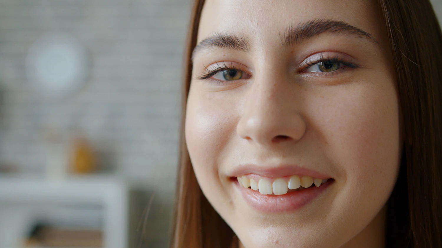 Close-up portrait of a young woman with smooth, natural skin and light makeup before a preventative micro-dose Botox consultation
