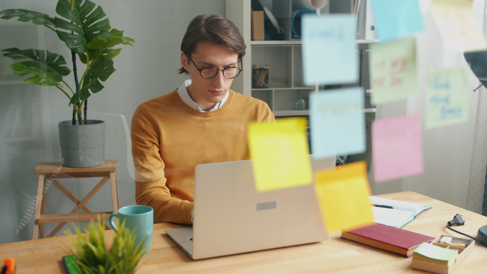 Person working at a laptop with planning notes while building an affiliate website