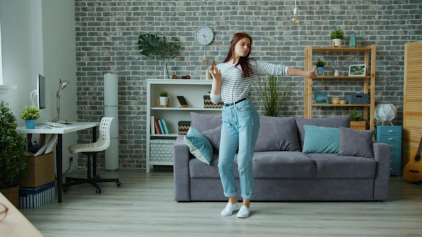 Young woman dancing happily in a modern living room