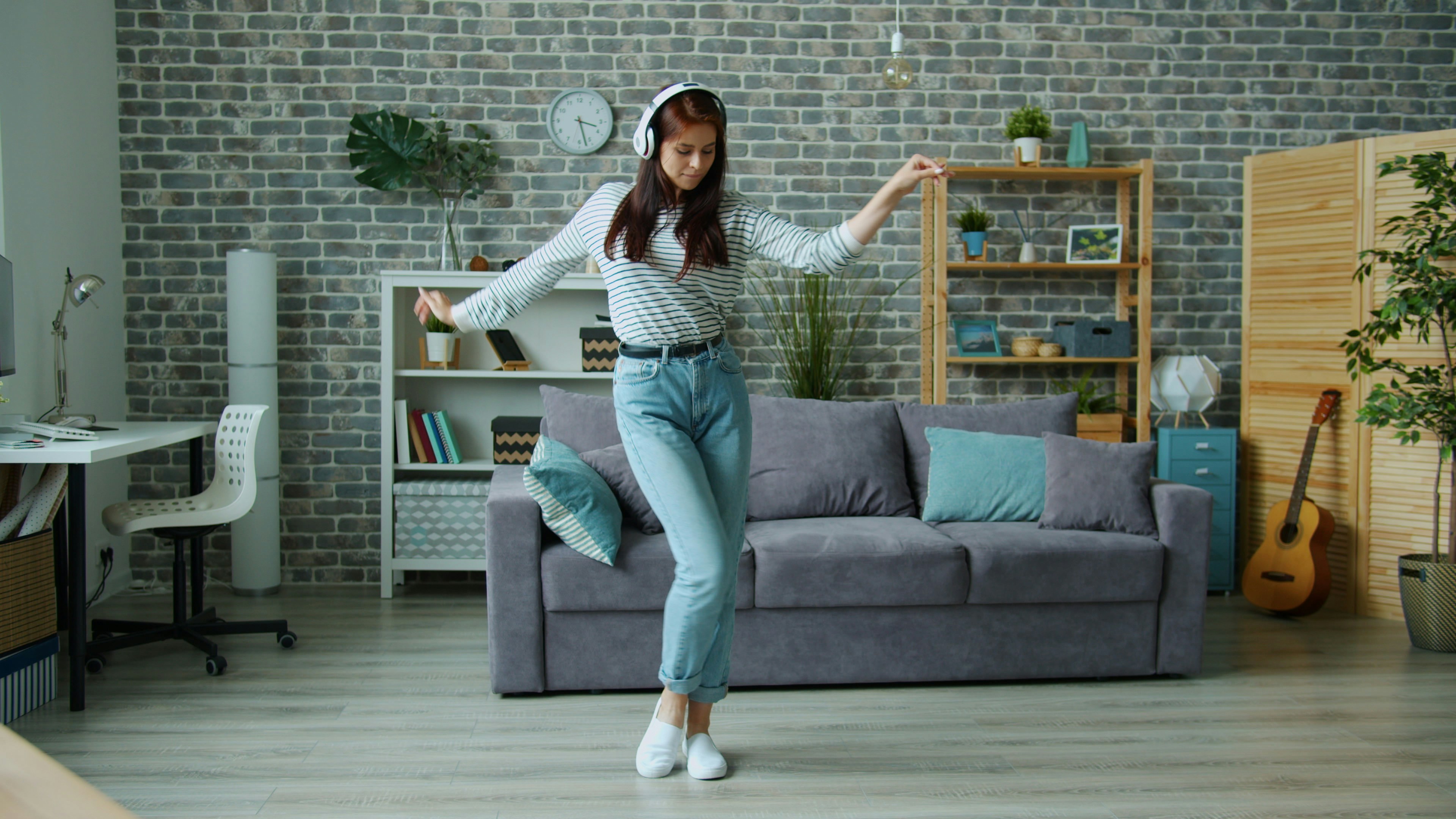 person dancing alone at home living room