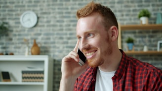 Man with red hair talking on a cell phone