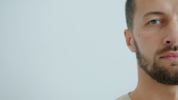 Man with beard against a light background
