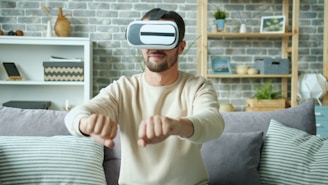 Man wearing vr headset playing game at home