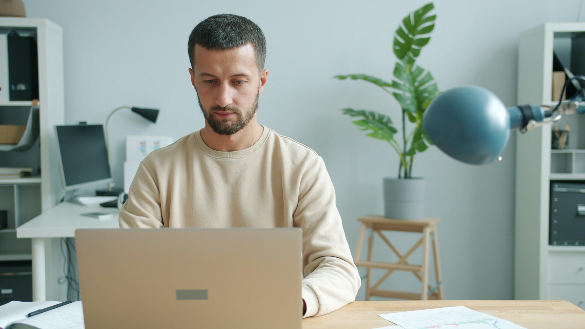 Man working on a laptop at a desk.