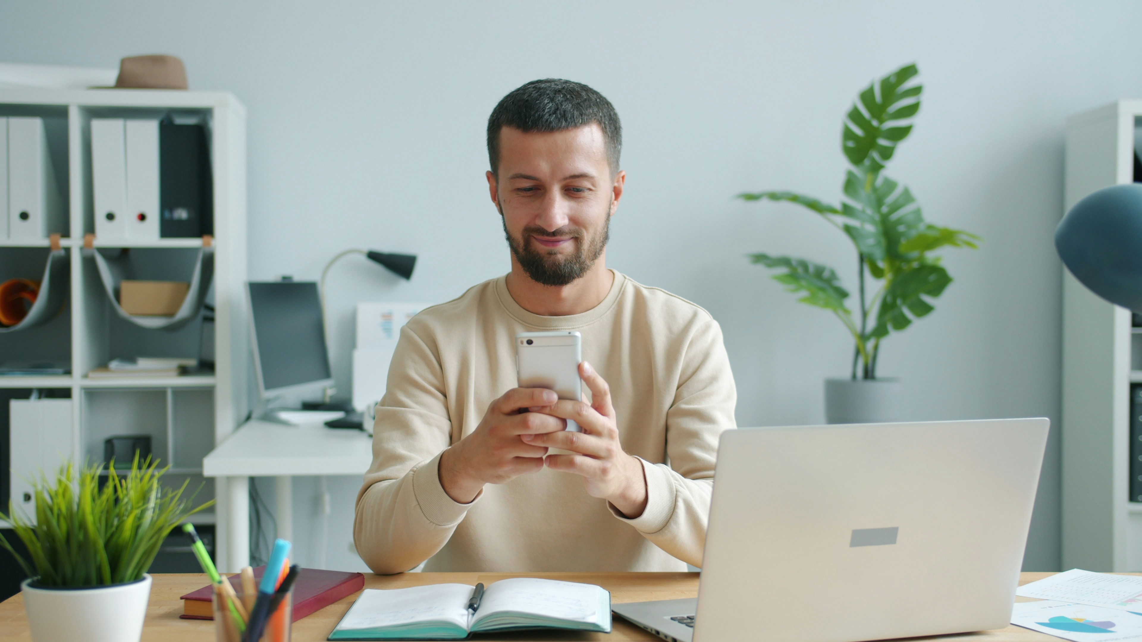 software engineer testing mobile application on desk