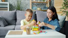 Mother and son building with colorful blocks