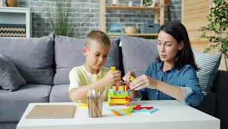 Mother and son building with colorful blocks