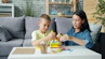 Mother and son building with colorful blocks