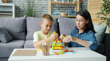 A parent and child building with colourful blocks
