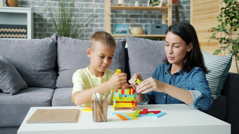 Mother and child building colorful blocks together at home