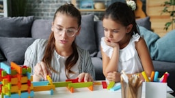 Woman and child building with colorful blocks