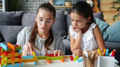 Woman and child building with colorful blocks