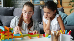 Woman and child building with colorful blocks