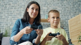 Mother and son playing video games together