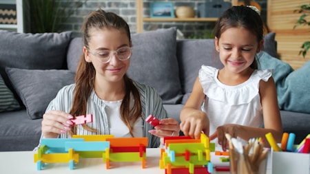Woman and child building with colorful blocks