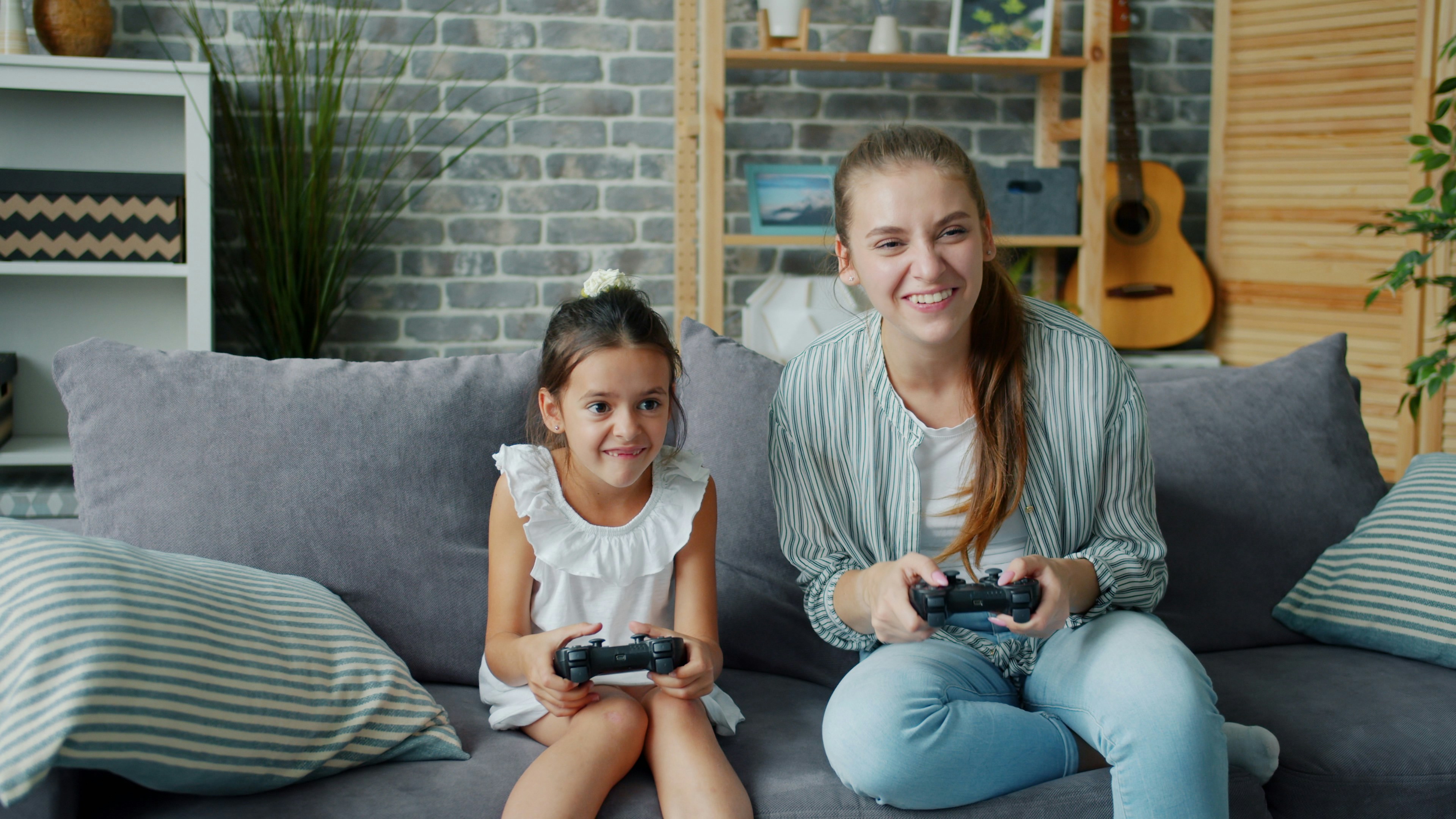 Mother and daughter playing video games