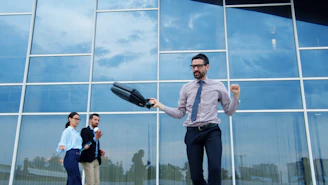 Man celebrating success outside modern office building