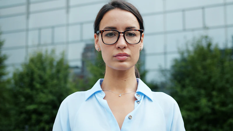 young professional woman in glasses outdoors