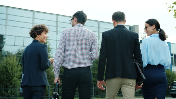 Four business people walking away from camera