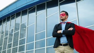 Man in superhero costume standing outside building