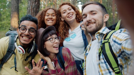 Group of friends taking a selfie in the forest