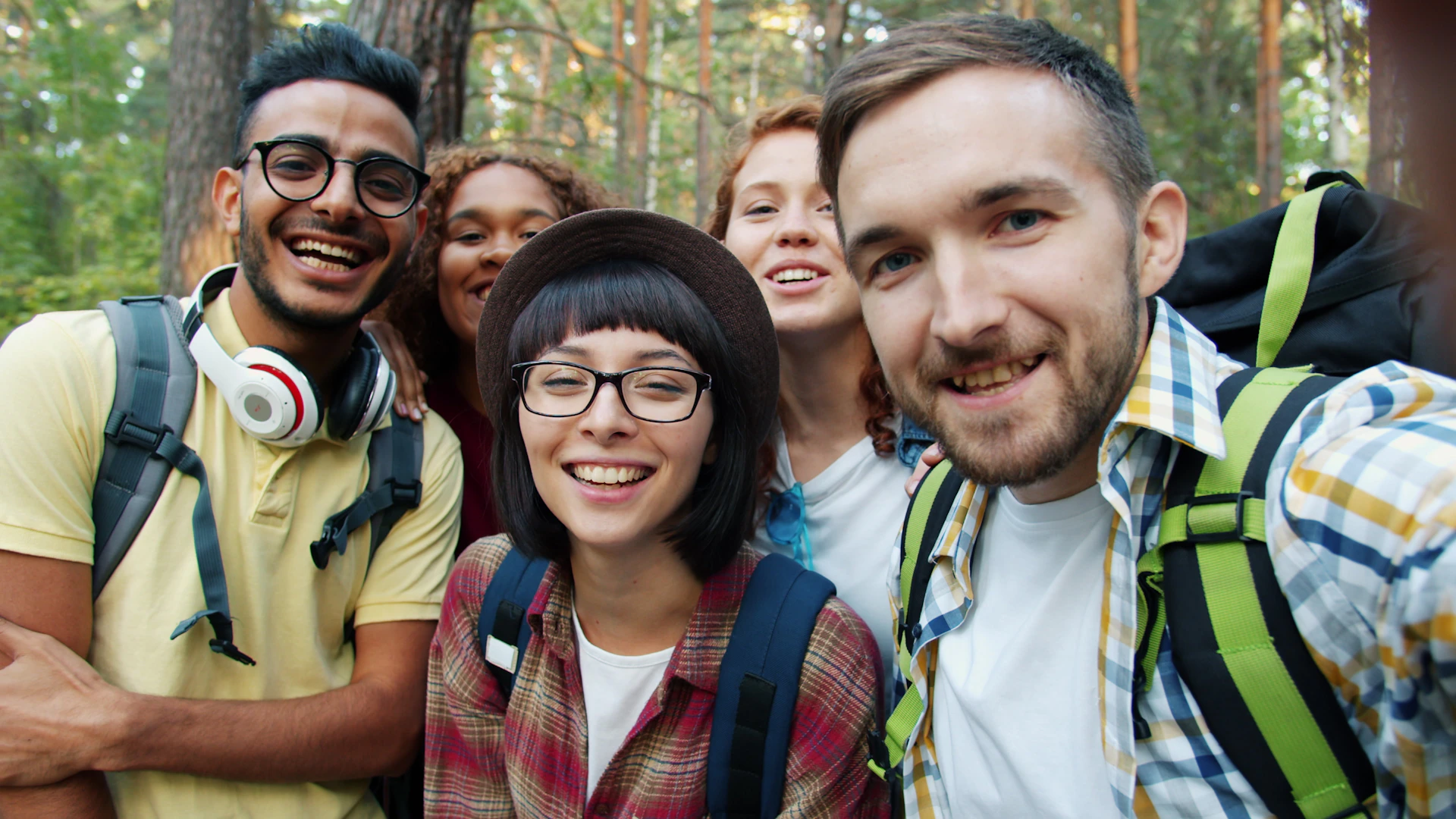 Group of friends taking a selfie in a forest
