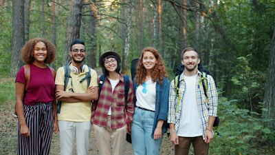 A diverse group of friends hiking in a forest