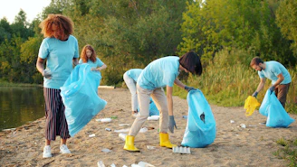 Volunteers cleaning up litter on a sandy shore