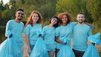 Diverse group of volunteers holding trash bags outdoors