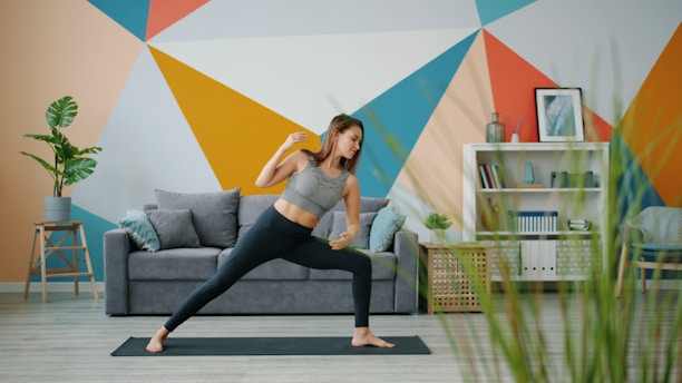 Woman practicing yoga in a brightly decorated living room.