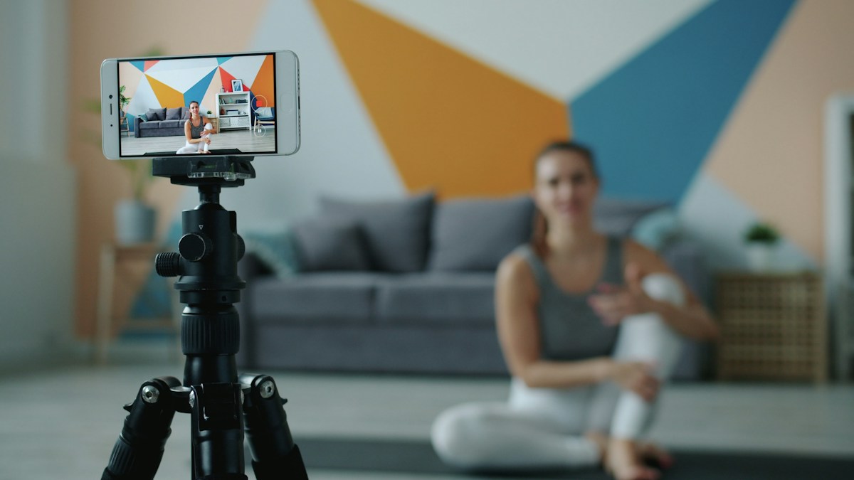 Creator recording video on a smartphone tripod