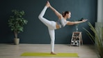 Woman in yoga pose on mat indoors
