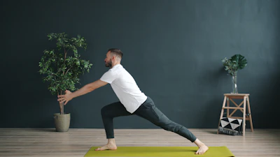 Man doing a yoga pose on a mat.